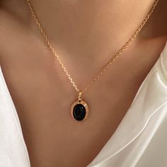 "Elevate your style with our exquisite Oval Black Onyx Pendant/Charm - a versatile Black Onyx necklace designed to effortlessly combine elegance and sophistication. This stunning piece offers three chain options: the edgy Satellite Chain, the timeless Classic Link Chain, or the elegant Pearls Chain. Whether you prefer a Minimalist, Dainty, or classic look, this pendant accommodates various styles, making it a true fashion chameleon Searching for the perfect gift for her? Look no further. This Oval Black Onyx Pendant/Charm combines different styles in one elegant piece, making it an ideal gift choice. Whether you're treating yourself or surprising a loved one, this necklace is sure to impress. DETAILED DESCRIPTION// Material: 925 sterling silver filled 18k gold Stone: natural black onyx Pen Luxury Elegant Onyx Necklace, Luxury Onyx Jewelry For Women, Luxury Timeless Onyx Jewelry, Elegant Black Oval Pendant Jewelry, Black Jewelry With Delicate Round Chain, Black Jewelry With Delicate Chain, Black Enamel Oval Necklace As Gift, Black Enamel Oval Necklace For Gift, Elegant Black Oval Pendant Necklace