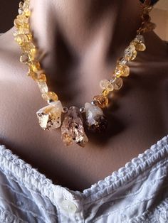 This organic, one of a kind necklace is created from 3 pieces of raw Citrine,with inclusions of dark black/eggplant colored Goethite at the bottoms of each gem.The middle ,largest Citrine is pale yellow, with a gorgeous shape, and is flanked by 2 smaller citrines that are a bit more yellow in color. I placed these beauties on freeform citrine beads of varying sizes.  Simply magnificent stones All findings and components are sterling silver.  Necklace length is approx. 18 inches. Natural Citrine Raw Citrine Necklace, Raw Citrine, Eggplant Color, Citrine Jewelry, Citrine Beads, Citrine Necklace, Natural Citrine, Pale Yellow, Sterling Silver Necklace