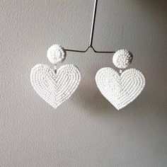 "Handmade white beaded Heart shape embroidered Earring Purely handmade seed beads embroidered heart earring looks so great. An ideal gift for bridesmaids. Earrings measure about approx. 2.10\" long and 2.10\" wide. PS: Carnation jewelry is handmade & handcrafted in India hence there is a possibility of a slight or small imperfection due to the fact that these are made by hand. I still make sure that every piece made here is perfect to look at. For more details, please see our shop policies f White Heart Beads Jewelry For Party, White Beaded Earrings With Heart Beads As A Gift, White Dangle Heart Bead Earrings, White Heart Bead Dangle Earrings, White Heart Beads Dangle Earrings, White Dangle Heart Earrings With Beads, White Heart Charm Earrings For Party, Dangle Beaded Earrings With Heart Beads For Party, Handmade Heart Earrings For Wedding