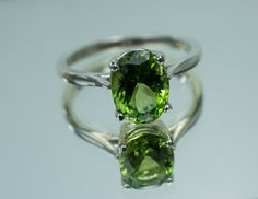 This is a beautiful Peridot from Pakistan set in Sterling Silver. This amazing stone has the perfect lime green color that many want with a great luster, and clarity!. Peridot is one of those underrated stones that has a quite remarkable history. Peridot is August's Birthstone. This nicely sized 9mm X 7mm Oval Peridot weighs 2.220cts and will go great with most styles or occasions. They will even go good with some of our Peridot Earrings located in our Gemstone Stud Earring Section. Please feel Classic Peridot Jewelry For May Birthstone, Lime Green Peridot Jewelry With Center Stone, Classic Green Gemstone With Center Stone, Elegant Green Peridot Gemstones, Green Peridot Jewelry With Prong Setting, Green Gemstones With Prong Setting For May Birthstone, Classic Peridot Jewelry With Prong Setting, Classic Peridot Jewelry With Accent Stones, Fine Jewelry Green Round Cut Gemstones