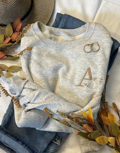 Neutral White Pumpkin Sweatshirt, personalized with a simple letter just for you!   Cute and cozy sweatshirt celebrating our favorite season!    Pair with your favorite jeans or leggings to complete your look.  Shown here in both oatmeal heather with multiple thread colors **Sizes S-XL the design will be approx. 2.5-3 inches tall, sizes 2X-3X the design will be approx. 3.5 inches tall.  Features: 50% USA cotton, 50% polyester Pill-resistant air jet yarn Made with 50% sustainably and fairly grown Fall Sweater Embroidery, Cozy Fall Sweatshirt Gift, Cozy Sweatshirt For Fall Gift, Long Sleeve Sweatshirt For Fall Gift, Cozy Sweatshirt For Fall, Cozy Fall Sweatshirt With Letter Embroidery, Fall Sweatshirt With Embroidered Logo For Loungewear, Cozy Sweatshirt With Letter Embroidery For Fall, Cozy Letter Embroidery Sweatshirt For Fall