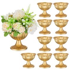 a bunch of gold vases with flowers in them