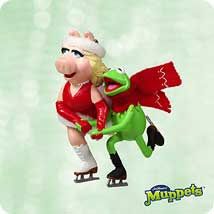 a cartoon pig riding on top of a skateboard next to a green frog wearing a santa hat