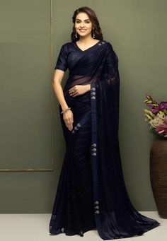 Navy blue chiffon designer saree with blouse SV215 Stylish chiffon sarees with a designer blouse, perfect for a chic appearance on casual occasions. Ideal for those seeking a simple yet elegant look.ish and timeless for years to come. Purchase these sarees exclusively at Kollybollyethnics. Desc:  Color : Navy blue Fabric : chiffon Work : stone  Blouse :Semi stitch Wash Care : Dry clean Sleeve Style : Half Sleeve Long Sleeves : Done only in Custom Stitch Sleeves Lining : Done only in Custom Stitch Bust Size : 32 to 42 Inches Occasion : Festival   Christmas   Eid   Ceremonial   Pongal   Lohri   Gudi Padwa   Onam   Ugadi   VaisakhiFancy saree chiffon saree light weight saree designer saree. With Express Free Shipping and Custom Stitching, Buy Indian Wedding Party Wear Saree Navy blue chi Blue Georgette Pre-draped Saree With Self Design, Blue Organza Unstitched Blouse Piece, Elegant Pre-draped Chiffon Saree, Blue Blouse With Sheer Dupatta, Evening Anarkali Blouse In Georgette, Festive Sheer Organza Saree, Elegant Chiffon Pre-draped Saree For Festivals, Elegant Sheer Blouse For Party, Elegant Blue Chanderi Pre-draped Saree