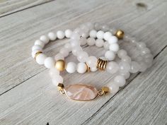 Gorgeous white stack features: -milky white with gold bead and spacers -matte white jade with matte gold hematite and gold spacers -white moonstone paired with a pink moonstone pendant. Pick one or all 3 of them. Choose your bracelet choice and your size from drop box. All your items will be packaged and shipped in a cotton filled kraft box. Adjustable White Gemstone Beaded Bracelets, White Gemstone Beads Stretch Bracelet As Gift, Adjustable White Beaded Bracelets With Gemstones, Adjustable White Crystal Bracelet With Gemstone Beads, Adjustable White Pearl Bracelet With Gemstone Beads, White Pearl Bracelet With Gemstone Beads For Spiritual Wear, White Stackable Crystal Bracelet As Gift, White Spiritual Stretch Bracelet With Gemstone Beads, Spiritual White Pearl Bracelet With Gemstone Beads