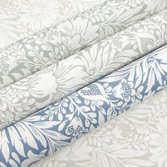 four different types of wallpaper with blue and white floral designs on the sides, all lined up together