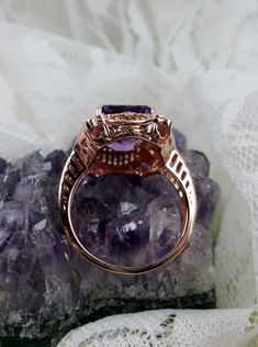 Natural Purple Amethyst Rose Gold plated Sterling Silver RingPicture Frame Design#D227 Inspired by Victorian era designs, this is a lovely reproduction ring. This lovely filigree handcrafted sterling silver ring is overlaid with rose gold plating. This flawless 5 carat Natural Purple Amethyst is 11mm x 9mm. The ring is 11/16" (17.5mm) North to South on the finger. The inside of the band is marked 925 for sterling silver. Notice the beautiful daisies on the outside of the setting and band. There Luxury Rose Gold Amethyst Ring As Gift, Classic Amethyst Rose Gold Jewelry, Intricate Rose Gold Sterling Silver Jewelry, Classic Rose Gold Amethyst Jewelry, Fine Jewelry Amethyst Ring With Intricate Design, Fine Jewelry In Rose Gold With Amethyst, Rose Gold Amethyst Fine Jewelry, Fine Jewelry Amethyst Ring With Intricate Design For Wedding, Fine Jewelry Amethyst Ring With Intricate Design For Anniversary