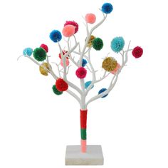 a white tree with multi colored pom - poms on it