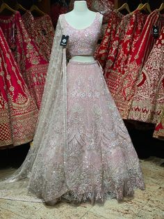 Bubblegum pink intricate with fully sequence, studs motifs thread embroidery and crystal stone flared lehenga embellished with pearl design.Styled with a matching blouse and net dupatta. Bubblegum pink gorgeousness is undoubtedly enchanting ensemble to style your wedding look. Fabric: Net Custom designed according to client measurements and color preference. Production and delivery time is 120 days! Anarkali Lehenga With Pearl Embroidery For Festivals, Pink Bollywood Choli For Designer Wear, Pink Sharara With Mirror Work For Reception, Designer Lehenga With Pearl Embroidery For Diwali, Designer Pearl Embroidered Lehenga For Diwali, Pink Mirror Work Sharara For Reception, Designer Pearl Embroidered Lehenga For Festivals, Designer Lehenga With Intricate Embroidery In Pink, Pink Hand Embellished Sharara For Diwali