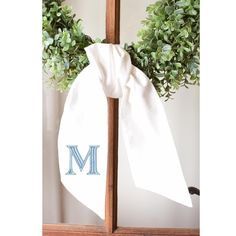 a wreath with the letter m on it and a monogrammed bow tied to it