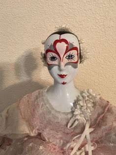 a white mannequin with a red heart painted on it's face