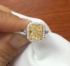 5 CT Yellow Radiant Cut Moissanite Diamond Side two Tone Round Cut Diamond In Band 10K 14K 18K Solid White Gold Engagement Ring Wedding Ring R I N G M E T A L ✥ Metal : 10K 14K 18K Solid White Yellow and Rose Gold, 925 Sterling Silver ✥ Metal Clarity : 100% Pure ✥ Stamp/Hallmark : Yes. Will be Indicated Inside The Ring M A I N S T O N E S ✥ Type : Moissanite  Diamond ✥ Center Diamond Shape : Radiant Brilliant Cut Diamond ✥ Center Diamond Weight : 4 CT ✥ Center Diamond Color : Yellow ✥ Side Diamond Shape : Round Cut Diamond ✥ Side Diamond Weight : 1.2 CT ✥ Clarity : VVS1 ✥ Diamond Cut : Excellence R I N G S I Z E S ✥ All Ring Size are Available ✥ Free Sizing ✥ If You Have any Questions With Regards to Sizing Please Contact as ✥ Please Send me a Message If You Need a Size not Listed S H I P Yellow Platinum Diamond Wedding Ring, Gia Certified Yellow Gold Diamond Ring For Wedding, Yellow Diamond Ring For Wedding, Yellow Emerald-cut Diamond Wedding Ring, Gia Certified Yellow Diamond Wedding Ring, Yellow Gia Certified Diamond Ring For Wedding, Yellow Gia Certified Diamond Wedding Ring, Gia Certified Yellow Wedding Ring, Radiant Cut Yellow Jewelry For Wedding