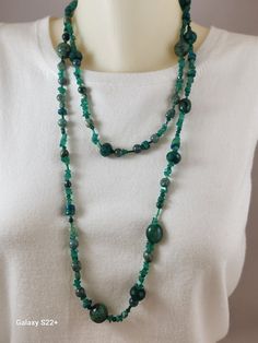 This necklace is one of my specialties.  It is a mixed lot of deep green natural stones.  There are emerald chips, green aventurine, Pearls, Ruby Zoisite, Chrysocolla, Swarovski Bicone crystals, Jade, all strung in a random fashion. It is strung on nylon fishing line, making it very strong.  There is no clasp, just wrap and go, Green Crystal Necklaces With Stones For Spiritual Style, Green Moss Agate Round Bead Necklaces, Green Moss Agate Round Bead Necklace, Green Chrysocolla Round Bead Necklaces, Green Chrysocolla Round Beads Necklace, Green Emerald Beaded Necklaces For May Birthstone, Green Crystal Necklaces For Healing, Green Chrysocolla Gemstone Beads Jewelry, Green Emerald Beaded Necklace For May Birthstone