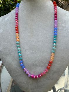 Embrace the vibrant energy of the rainbow with the Rainbow Radiance Chakra Necklace. This eye-catching piece features a gradient of colorful beads, each corresponding to one of the seven chakras. Designed to balance your energy centers, this necklace is not only a beautiful accessory but also a powerful tool for spiritual alignment and healing. Wear it to infuse your day with positivity and harmony. Materials: Mixed gemstones (Amethyst, Carnelian, Aventurine, and more) Length: 20 inches Closure: Toggle clasp Bohemian Rainbow Crystal Necklaces With Colorful Beads, Bohemian Rainbow Crystal Necklaces With Faceted Beads, Bohemian Rainbow Crystal Necklace With Colorful Beads, Bohemian Rainbow Crystal Necklace With Faceted Beads, Adjustable Rainbow Crystal Necklace With Faceted Beads, Adjustable Rainbow Crystal Bohemian Necklaces, Adjustable Rainbow Crystal Bohemian Necklace, Rainbow Faceted Beads Necklace For Gift, Adjustable Rainbow Bohemian Crystal Necklace