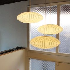 three lights hanging from the ceiling in a room