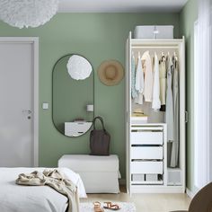 a bedroom with white furniture and gray walls