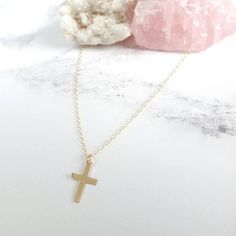 This minimal crucifix necklace is made of 14 karat gold filled. Its simple yet chic making it perfect as a baptism gift, holy communion or fashion accessory. All my pieces come boxed and ready for gift giving.  Measurements: Pendant - 16mm  WHAT IS GOLD FILLED? Gold filled material is solid gold bonded onto a base metal (copper). It contains 100 times more gold than gold plated jewellery. With daily wear your piece of jewellery can last up to 10 years! Rose gold filled is a great option for t... Minimalist Crucifix Charm Necklace As Gift, Gold Crucifix Charm Necklace In Minimalist Style, Gold Minimalist Crucifix Charm Necklace, Minimalist Gold Crucifix Charm Necklace, Gold Minimalist Personalized Cross Necklace, Gold Personalized Minimalist Cross Necklace, Minimalist Personalized Gold Cross Necklace, 14k Gold Filled Cross Necklace Gift, 14k Gold Filled Cross Pendant Necklace As Gift