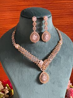 Add a touch of elegance and sophistication with this gold and silver finish necklace set in beautiful clear stones. The stones in this set bling and look close to the real thing. This set is sure to make heads turn!  It features an adjustable necklace and a pair of earrings. It can be paired perfectly with both ethnic and western outfits.  In case of any queries, please feel free to reach out. Happy shopping!   Length: 16 inches with an adjustable high quality metal chain at the back Earrings length: 2 inches Each earring weighs 10 gms  Closure: Pushback Dazzling Crystal Jewelry Set With Stone Setting, Wedding Jewelry With Cubic Zirconia Stone Setting, Cubic Zirconia Wedding Jewelry With Stone Setting, Wedding Cubic Zirconia Stone-set Jewelry, Crystal Jewelry Sets With Stone Setting For Wedding, Silver American Diamond Jewelry Sets With Stone Setting, Dazzling Wedding Jewelry Sets With Stone Setting, Silver Gold-plated Bridal Sets For Party, Cubic Zirconia Jewelry Sets With Stone Work For Wedding