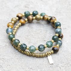 Feel the abundant energy of your Moss Agate and Tiger's Eye Mala Bracelet. Luxurious and casual deep green luxurious bracelet, perfect for layering with other bracelets. Made with genuine moss agate, matte hematite and tiger´s eye. Brass hand made beads support women in Africa. Contains 27 beads so its a wrist mala! St Women In Africa, Prosperity And Abundance, Aromatherapy Bracelet, Wrist Mala, Stone Bracelets, Diffuser Jewelry, Yoga Bracelet, Chakra Jewelry, Beaded Wrap Bracelets