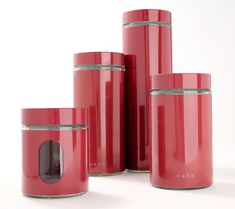 three red canisters are stacked on top of each other