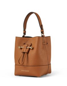 The Lana bucket bag is casual, chic and functional, making it perfect for everyday wear. The bucket silhouette is cut from premium leather, closes with a drawstring closure, and features a detachable crossbody strap for easier wear. Style it with easygoing dresses and sleek separates to instantly elevate any look. How To Wear Lug Sole Boots, Lug Sole Boots, Tan Bag, Beige Bag, Drawstring Bucket Bag, Leather Bucket Bag, Leather Bucket, Bag Style, Green Bag