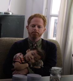 a man holding a small child on his lap