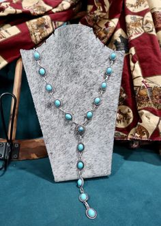 Round up style and charm with The Cowpuncher Lariat. This playful 24" necklace features a delicate silver chain and a fun oval turquoise concho. Wrangle in compliments with this quirky piece! Round Up, Up Styles, Silver Chain, Turquoise, Chain, Silver