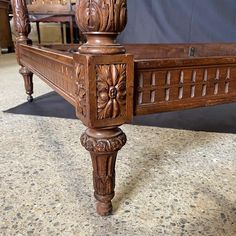 an antique bed frame with intricate carvings on it