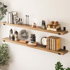 two wooden shelves with books and other items on them