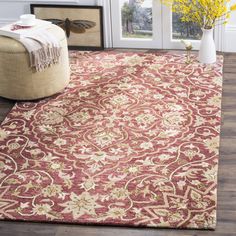 a red and beige rug in front of a door