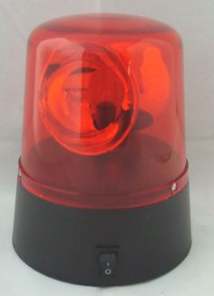 a red light sitting on top of a black stand