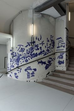 the stairs are covered in blue and white graffiti