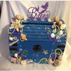 a blue trunk with seashells and pearls on it