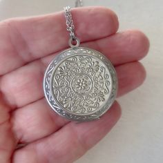 "This is a smaller version of a popular extra large locket in my shop. Timeless and classic, this beautiful embossed silver locket will become a special addition to your jewelry collection. The locket is 27mm in diameter (a little larger than a quarter), smooth silver plated brass, and opens for a secret place to keep pictures, messages, or whatever you like. The locket has a stainless steel chain with a lobster clasp. You may choose 18\", 20\" or 24\" length. This locket can hold two 22mm inser Vintage Silver Jewelry For Personal Use, Silver Pendant Locket Necklace With Engraving Option, Metal Medallion Locket Necklace Gift, Vintage Round Locket Necklace With Engraving Option, Round Locket Jewelry For Personalized Gift, Personalized Round Locket Jewelry Gift, Personalized Round Locket Jewelry, Stainless Steel Round Pendant Locket Jewelry, Round Locket Jewelry For Personal Use