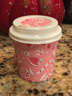 a pink cup sitting on top of a counter