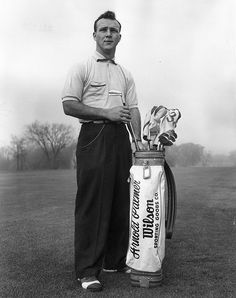 black and white photograph of a man holding a golf club next to a bag of golf clubs