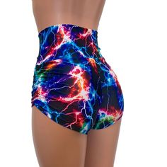 High-waisted booty shorts made in sparkle cosmic thunder UV Glow print stretchy performance spandex with ruching on the sides and lace-up detail in front. Made to flatter your figure and move with you. These booty shorts shine in different colors in the light - for a true holographic effect. The standard inseam is 2.5" - but can be customized. Stretch Rave Shorts, Fitted Rave Bottoms With Built-in Shorts, Fitted Rave Shorts, Trendy Fitted High Waist Athletic Shorts, Rave Bottoms With Built-in Shorts, Trendy Fitted Multicolor Biker Shorts, High Waist Stretch Bottoms For Rave, Multicolor Stretch Rave Shorts, Stretch Rave Shorts For Summer