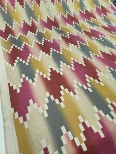 a large multicolored rug is laying on the floor