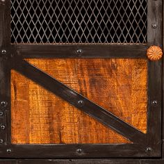 an old wooden gate with metal bars and knobs