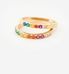 Meet our Mini Rainbow Band Ring- this whimsical piece is adorned with an arc of meticulously selected CZ stones, each shimmering with the joyous hues of the rainbow. Perfect for the color-loving daydreamer, this ring is more than an accessory—it's your very own piece of wearable joy. Rainbow Birthstone Ring For Anniversary, Multicolor Stackable Rings For Promise, Multicolor Open Stackable Rings For Promise, Multicolor Rings With Sparkling Stones For Gift, Adjustable Multicolor Birthstone Rings, Multicolor Stackable Birthstone Ring For Promise, Multicolor Stackable Birthstone Promise Ring, Rainbow Cubic Zirconia Jewelry For Wedding, Adjustable Multicolor Birthstone Promise Ring