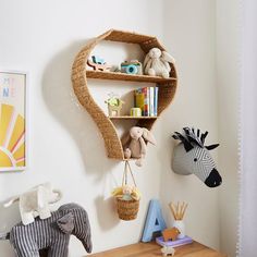 a shelf with stuffed animals and toys on it in a child's room or playroom