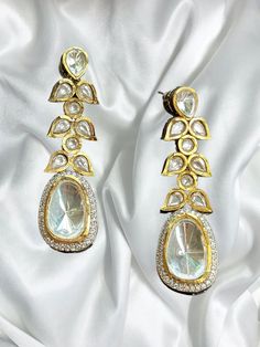 Beautiful uncut polki vintage earrings with gold diamond work and a modern luxurious look for any jewelry lover! The earrings are inspired by the royal princely states of rajasthan and have handwork done with diamond work added for a luxurious look! This lightweight and elegant earring is perfect for any bridesmaid, bride, sangeet or any occasion or event as a gift for any occasion as any one who loves jewelry will love this statement piece. It has beautiful colors that really make the set a statement piece. There are 4 colors available in these earrings and each of them are made with the highest quality stones. Product Details: * Earrings  Ready to Ship and available immediately if you place an order today! Fast Shipping US Customers receive your order within 5-7 business days. This is th Luxury Gold Jhumkas With Stone Work, Luxury Hand Set Bollywood Earrings, Luxury Gold Plated Bridal Earrings With Meenakari, Elegant Kundan Bridal Earrings With Stone Work, Festive Stone Work Chandelier Earrings For Reception, Festive Chandelier Earrings With Stone Work For Reception, Intricate Design Drop Earrings For Reception, Elegant Bridal Earrings With Kundan And Cutdana, Elegant Kundan Bridal Earrings With Cutdana