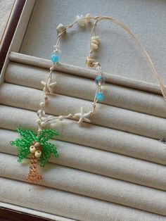 a beaded necklace with a palm tree on it