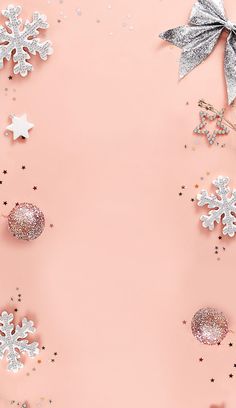 snowflakes and stars on a pink background with silver confetti ornament