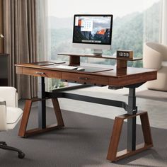 a wooden desk with a computer monitor and keyboard on it in front of a window