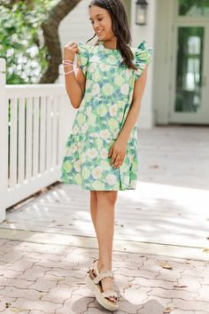 This dress is just precious! The floral print and those colors are absolutely perfect for the upcoming spring season! The little ruffled detailing around the neckline and sleeves are so girly and cute! Round neckline Short ruffled sleeves Button keyhole back Floral print Babydoll cut Runs SHORT. We recommend sizing up one size for extra length. No stretch Holland is wearing the medium. Floral Babydoll Dress, Mint Julep Boutique, Nature Green, Girls Sweet, Ruffled Sleeves, Model Fits, Spring Season, Babydoll Dress, Round Neckline