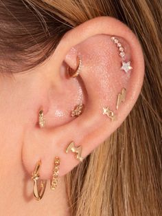 a woman's ear with three different types of piercings on the top and bottom