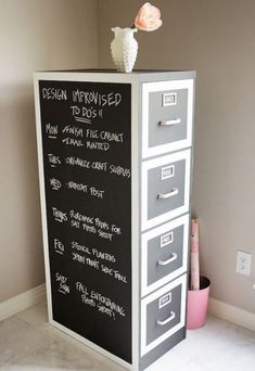 a chalkboard with drawers on top of it