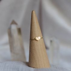 Aspire to always have a heart of gold. - Made with 14k gold filled material - 1mm thick band, 5x7mm heart shaped accent - Optional initial stamp You may experience a slight color difference in places where the metal has been soldered making every piece truly unique. If you do not see your size, please reach out to us by email at info@hellorising.com. We believe that everyone deserves to wear beautiful jewelry. Purchase three or more rings and save 15% with discount code 'ring15'. Click here to v Minimalist Stackable Rings With Heart Charm For Anniversary, Minimalist Stackable Heart Ring For Promise, Heart Shaped Stackable Rings For Valentine's Day, Heart Shaped Stackable Rings For Everyday, Adjustable Heart Shaped Stackable Rings For Everyday, Everyday Stackable Heart Ring, Stackable Everyday Heart Ring, Adjustable Minimalist Heart Ring For Promise, Minimalist Everyday Stackable Heart Rings