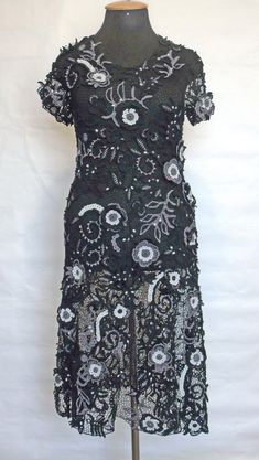 a black dress with white flowers on it